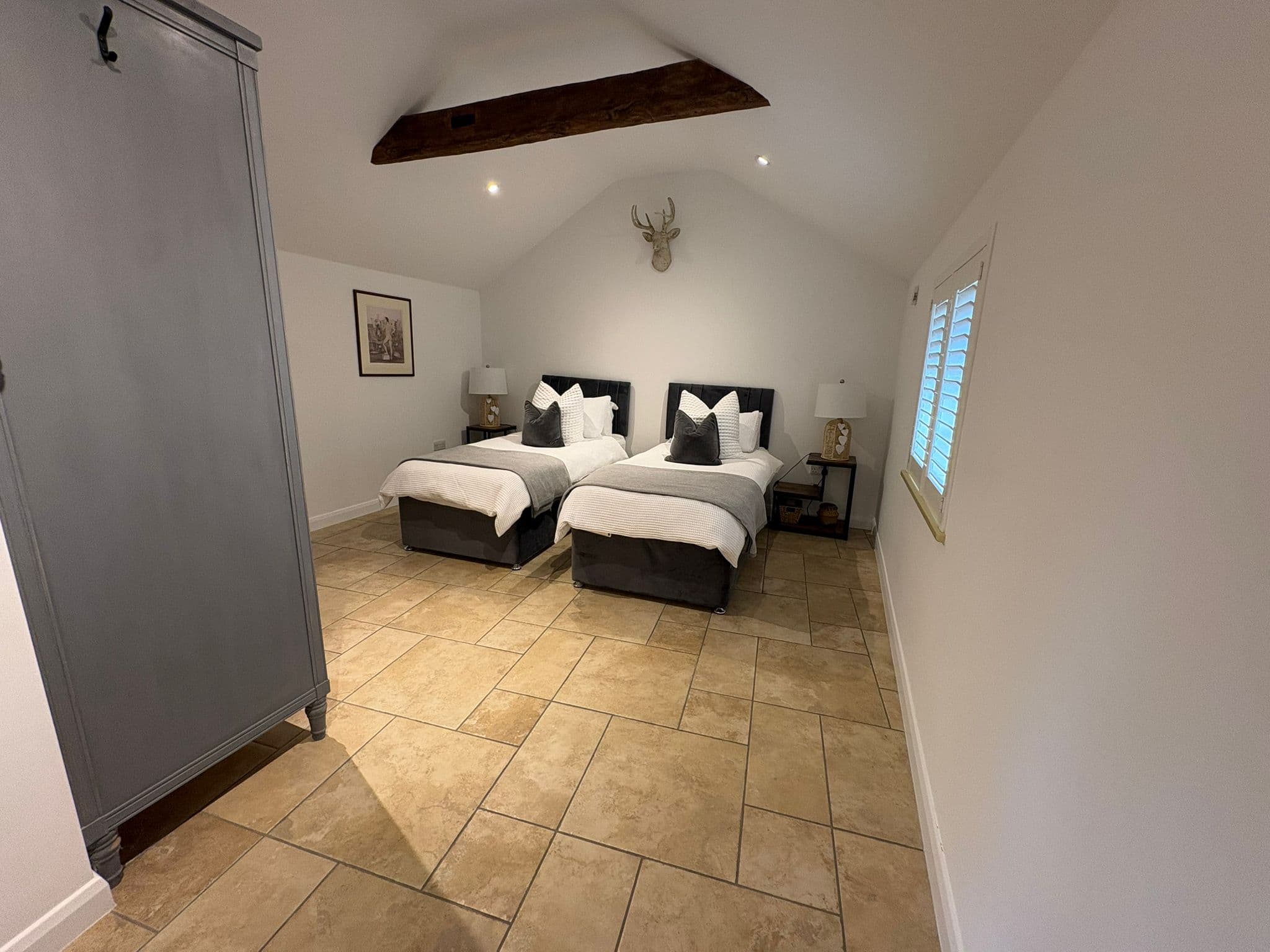 A neat, guest-ready twin bedroom in a holiday let